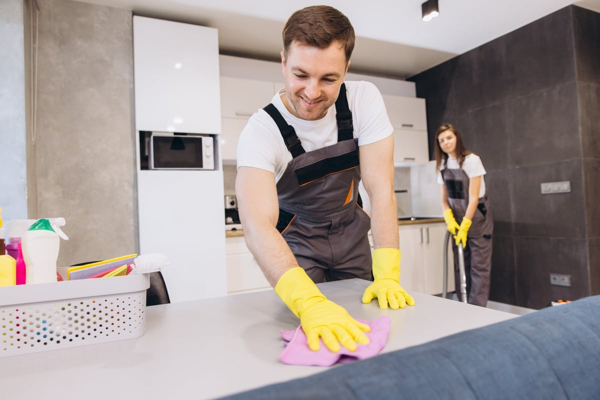 Professional cleaning team in uniform cleaning a kitchen — A-List standard cleaning service