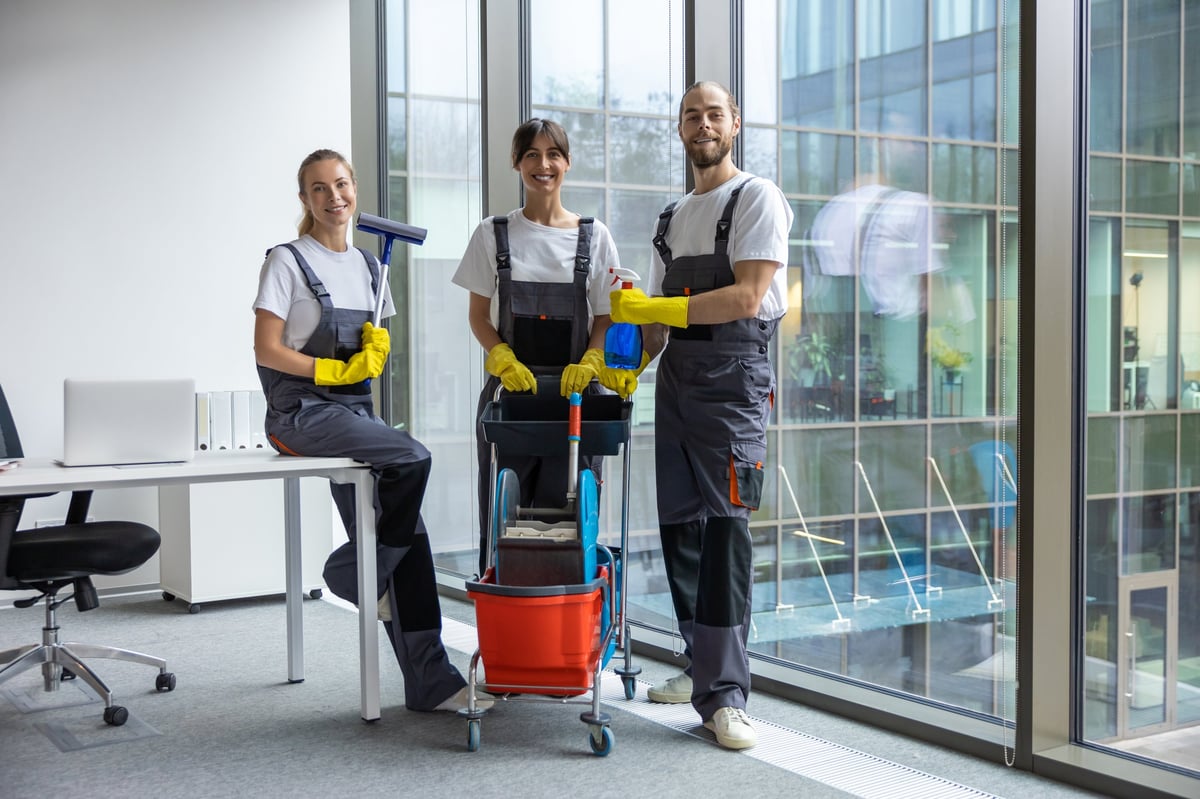 Professional housekeeping team standing confident — A-List Cleaners apartment cleaning crew