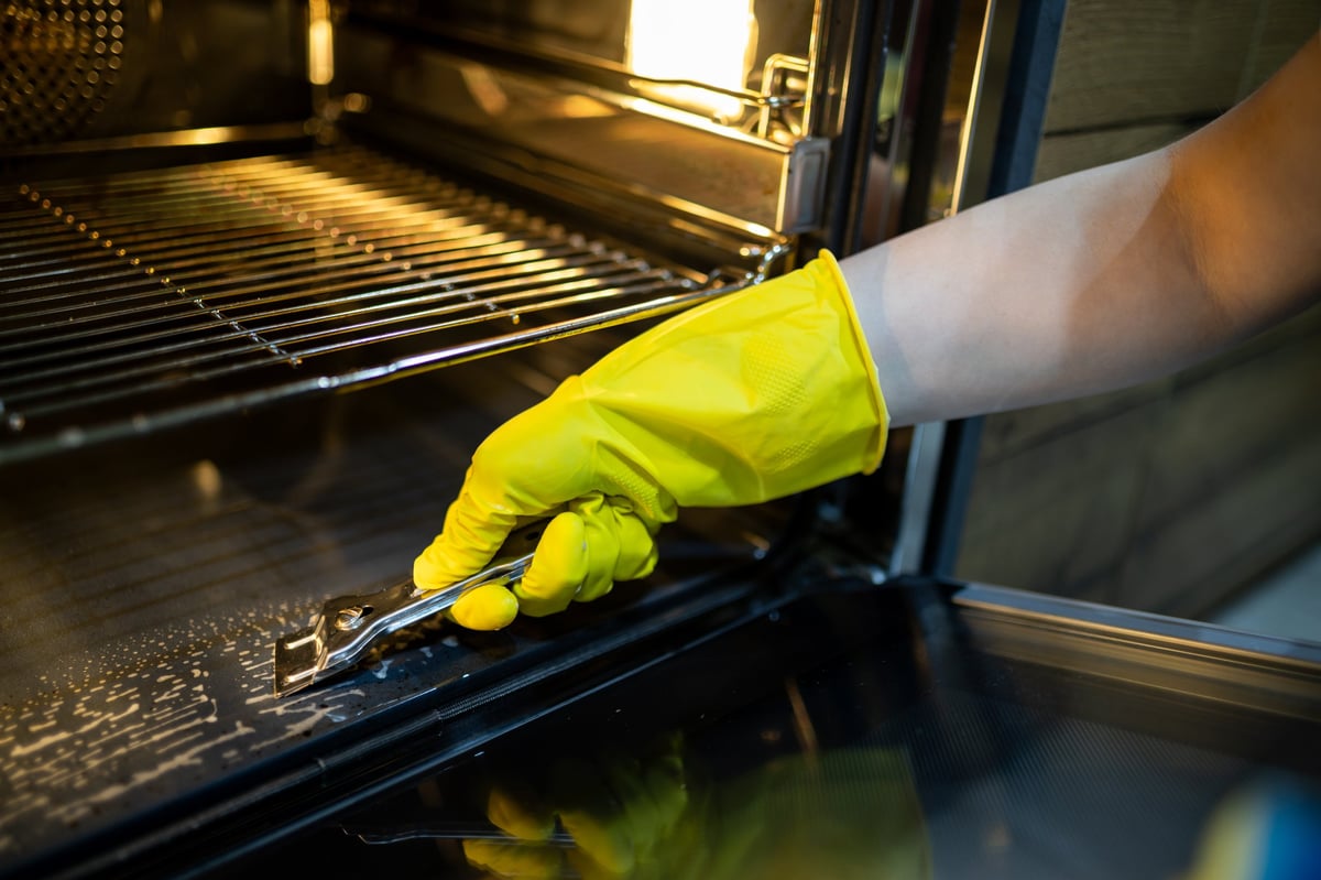 Professional deep cleaning of oven interior — removing grime and grease from every surface