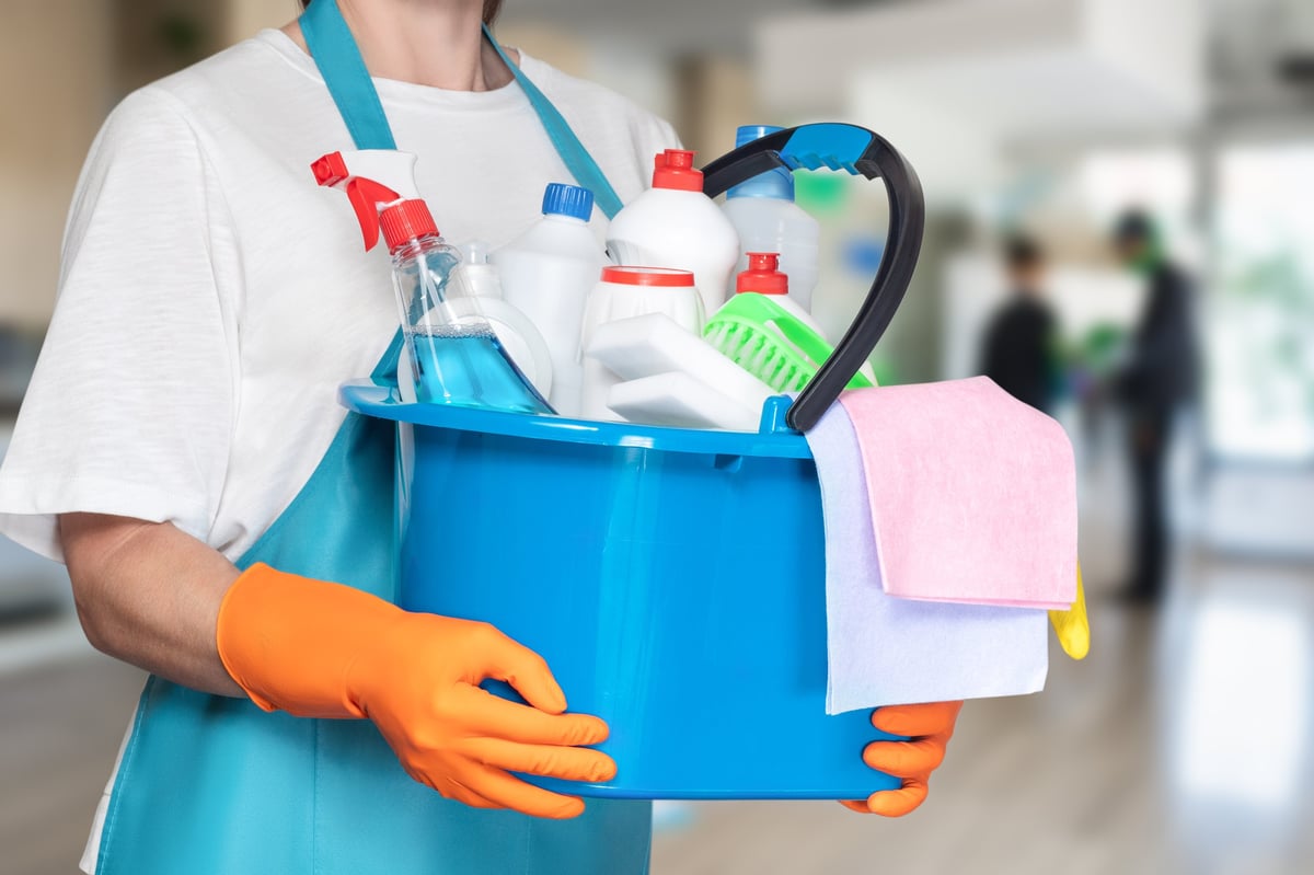 Bright blue bucket with professional cleaning supplies — ready for a thorough office cleaning session