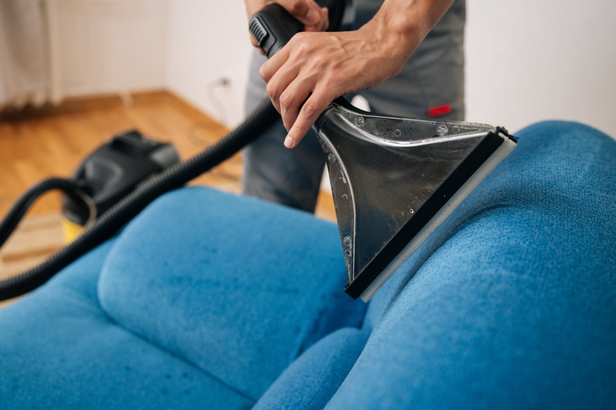 Professional deep cleaning of sofa upholstery — reaching every corner for a thorough refresh